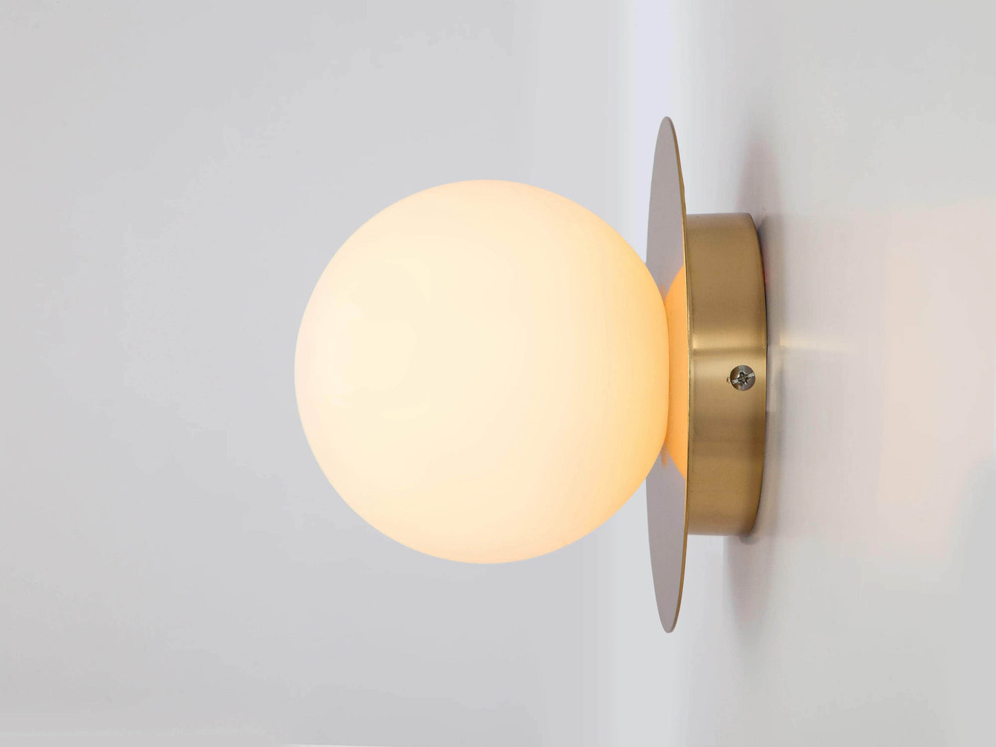 Brass opal disc wall light