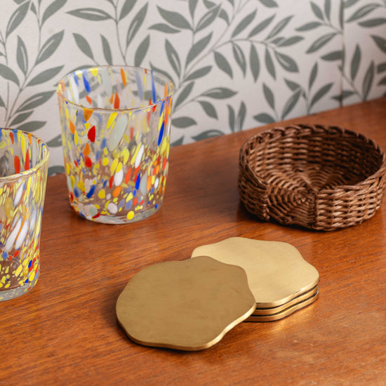 Wavy Brass Coasters in Rattan Holder - Set of Four