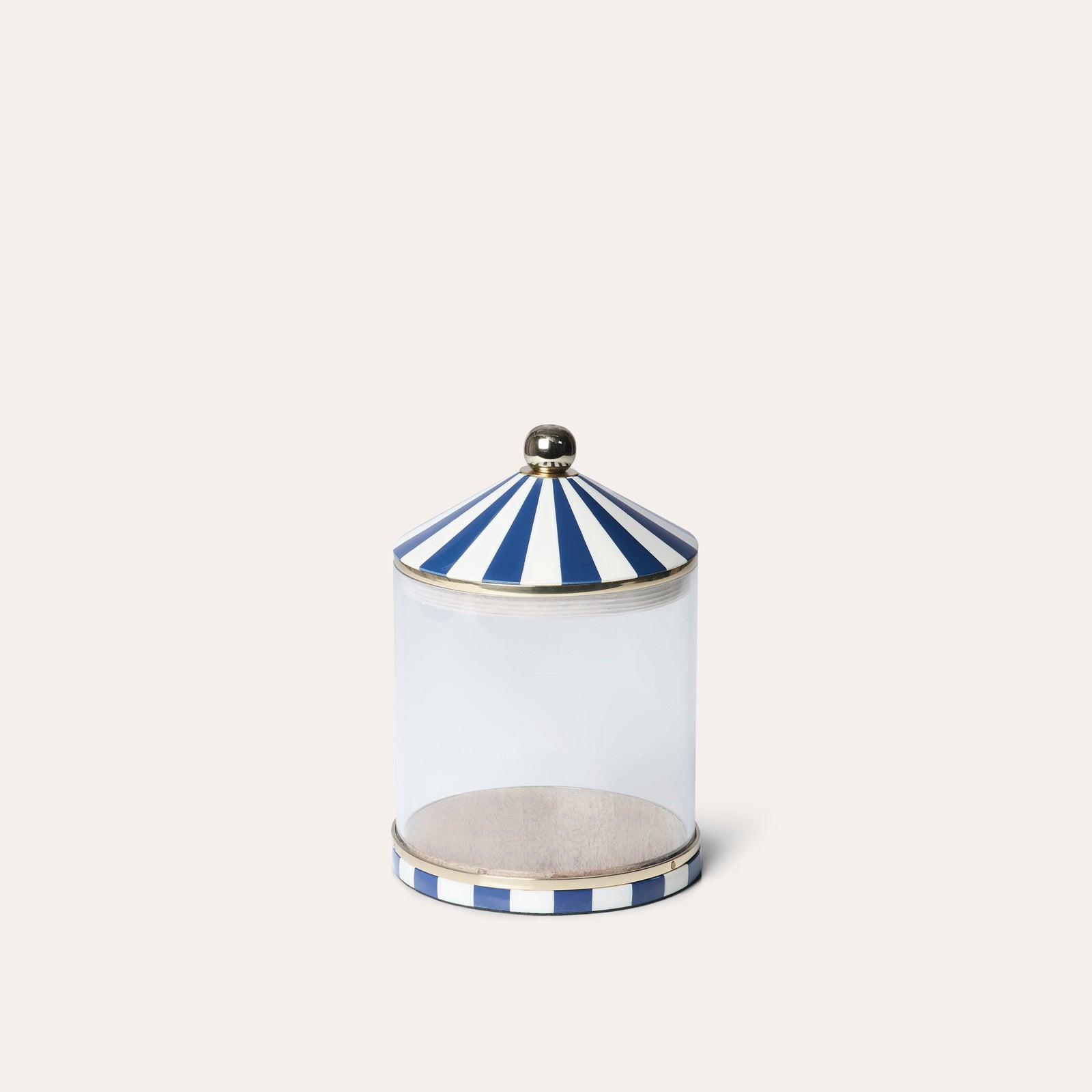 A clear acrylic storage jar with blue and white striped lid and base