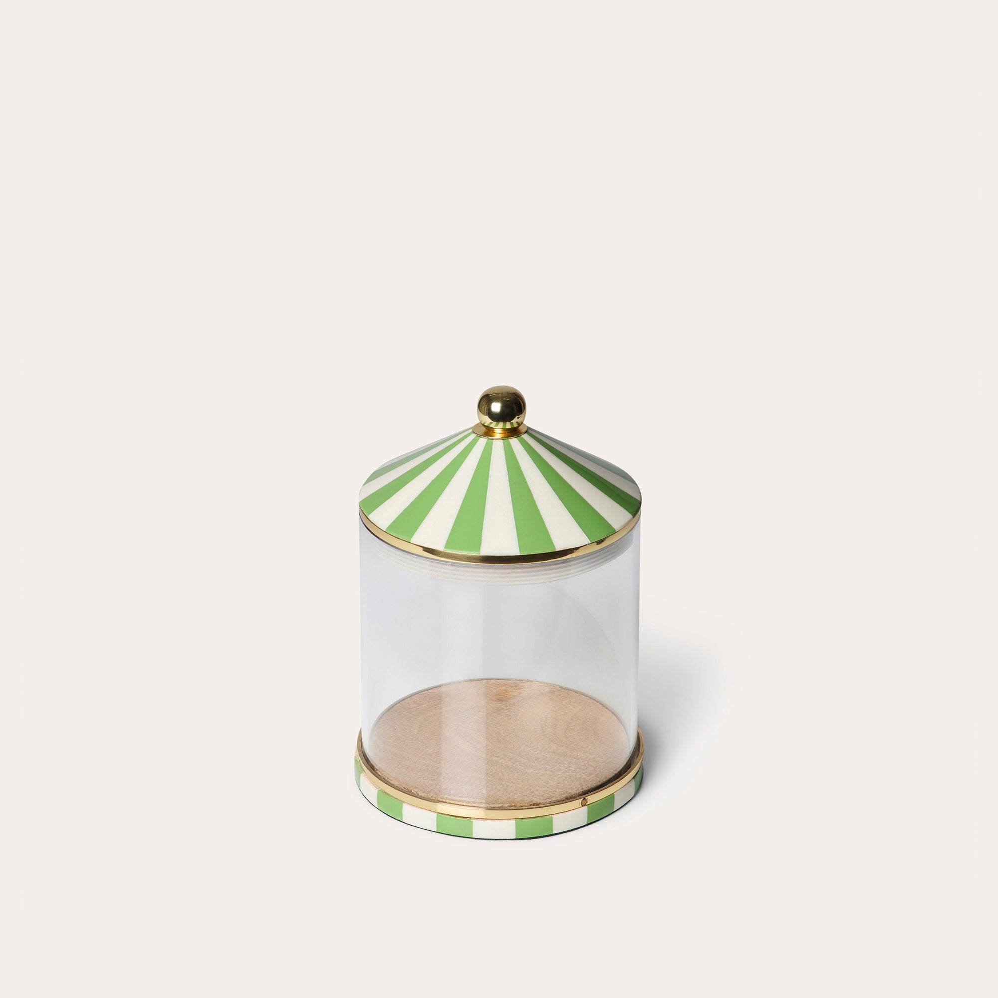 A clear acrylic storage jar with green and white striped lid and gold accents around the lid and base.