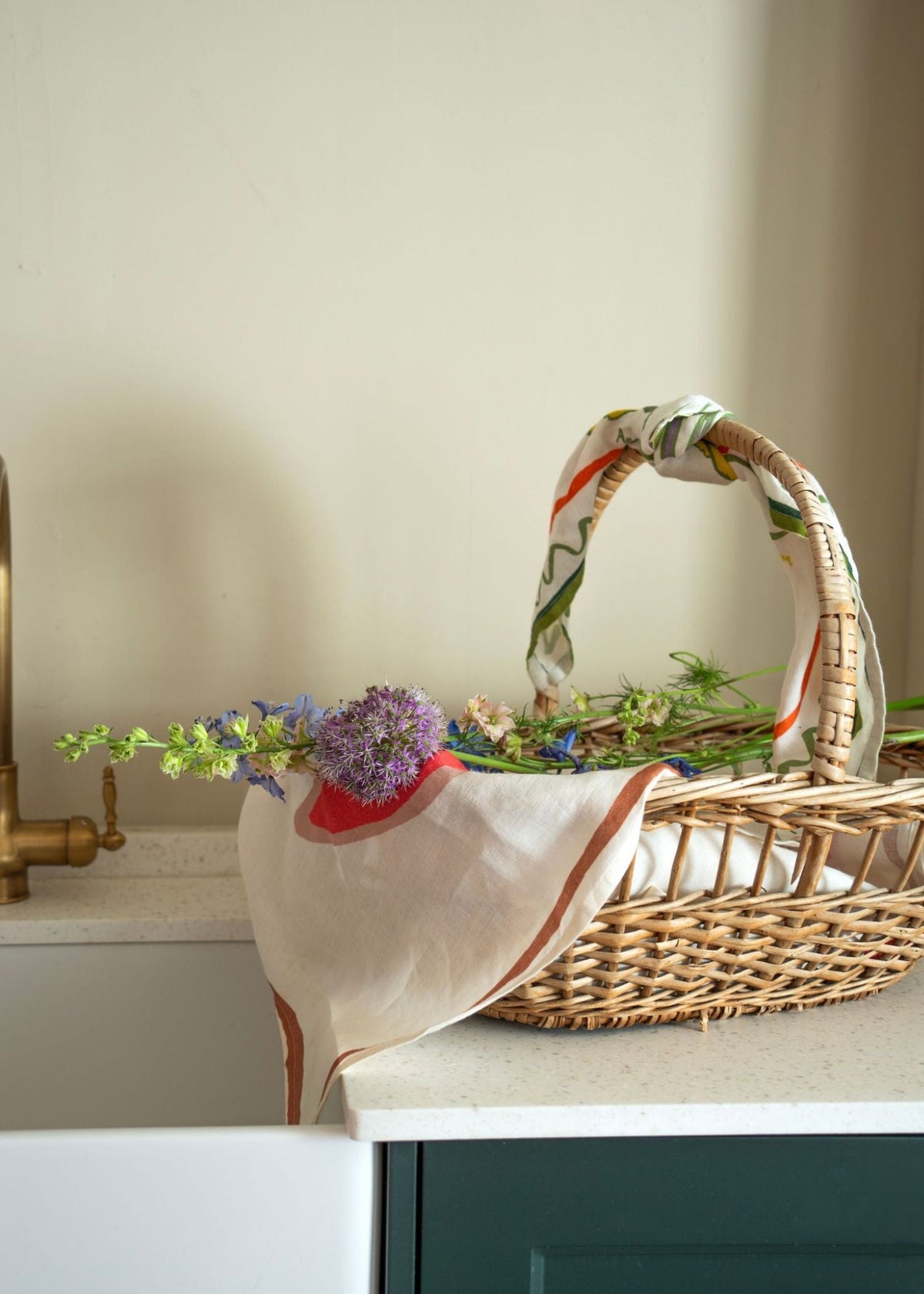 Basket and flowers layered with tea towel linen. Finished with a floral scarf by Amuse La Bouche