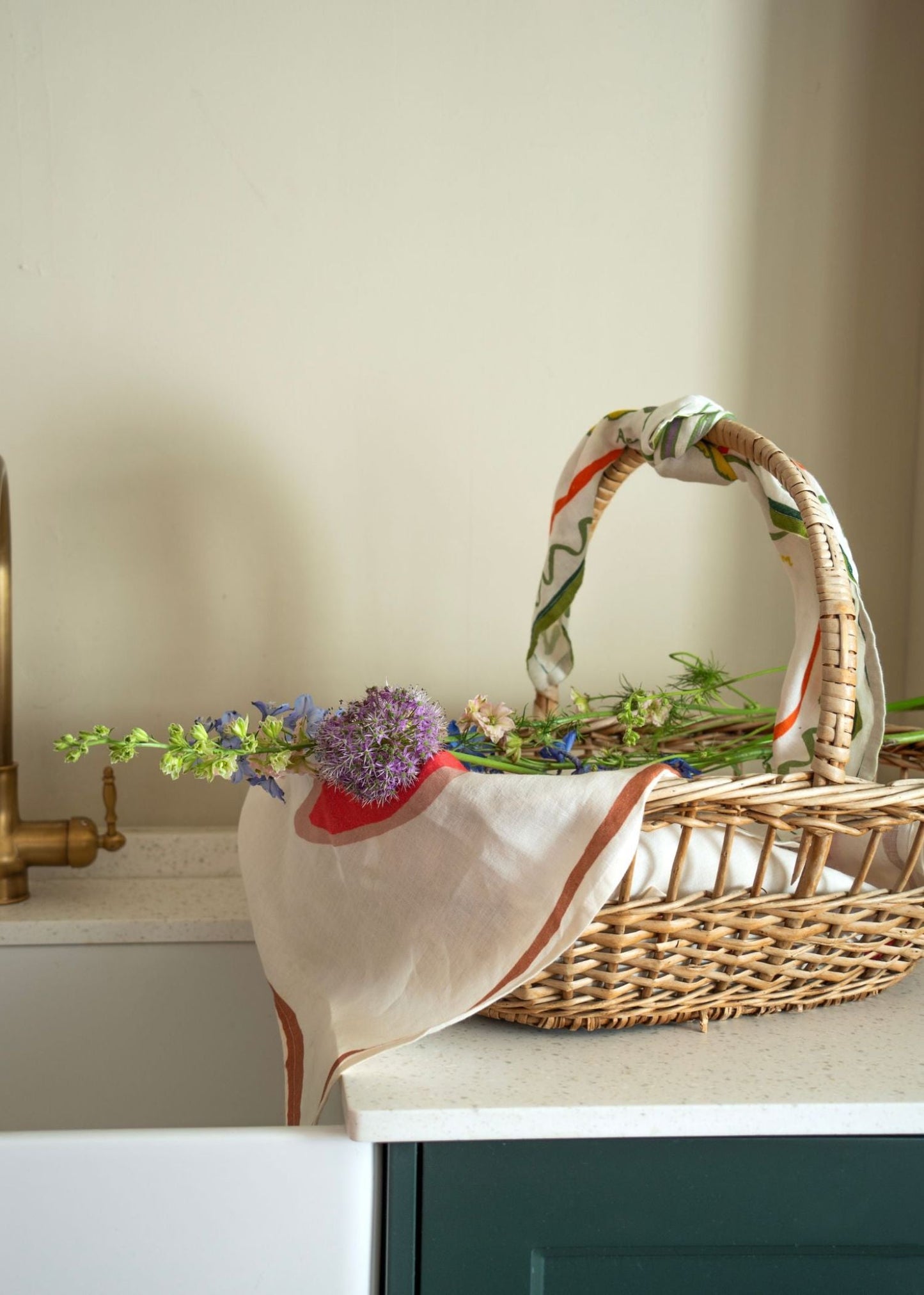 Basket and flowers layered with tea towel linen. Finished with a floral scarf by Amuse La Bouche