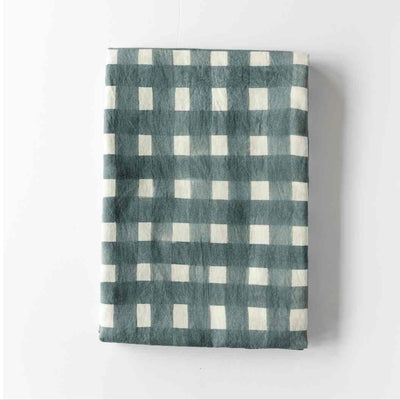 Blue Cross-Hatch linen tablecloth styled on elegant dining table - Goldie Home