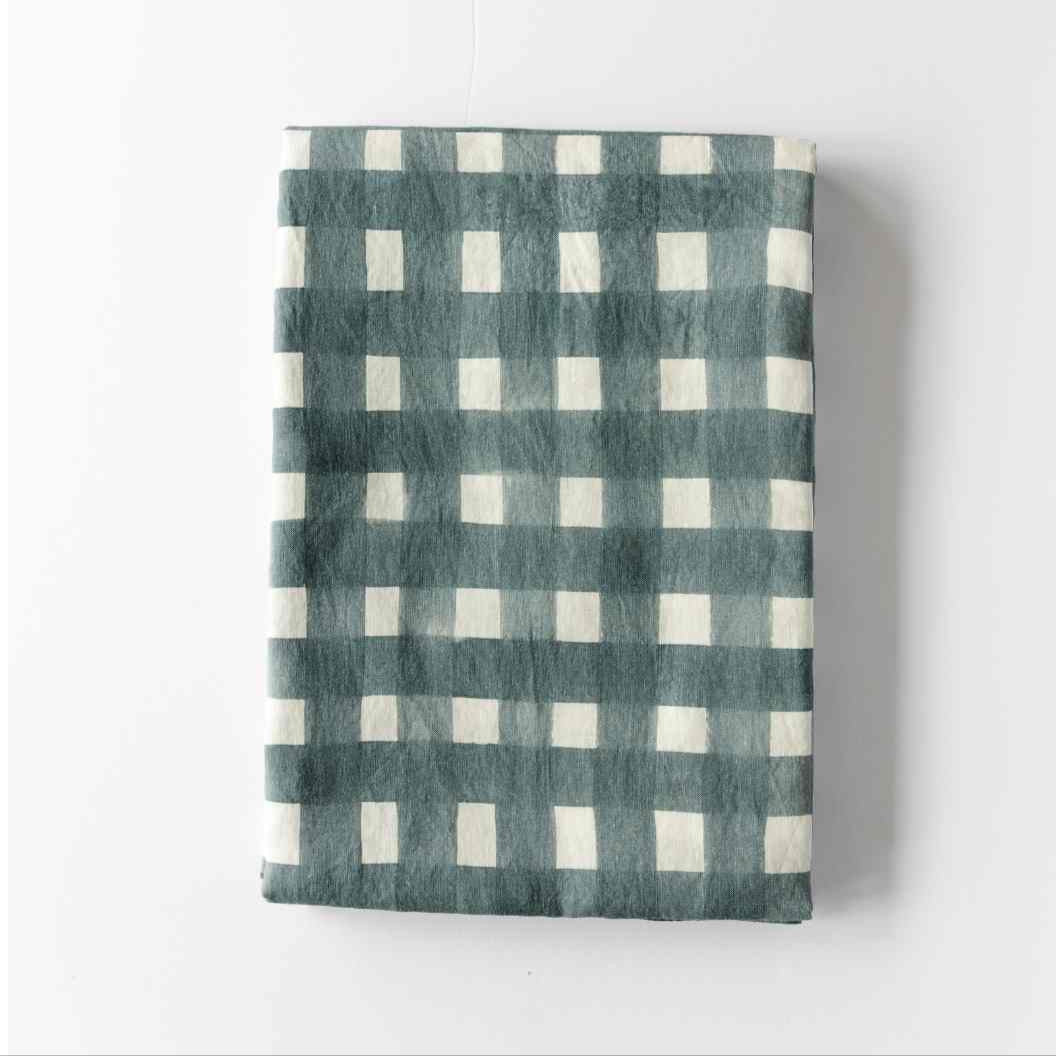 Blue Cross-Hatch linen tablecloth styled on elegant dining table - Goldie Home