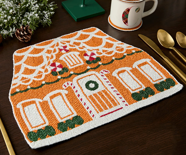 Close view of the bead work on a gingerbread house Christmas placemat