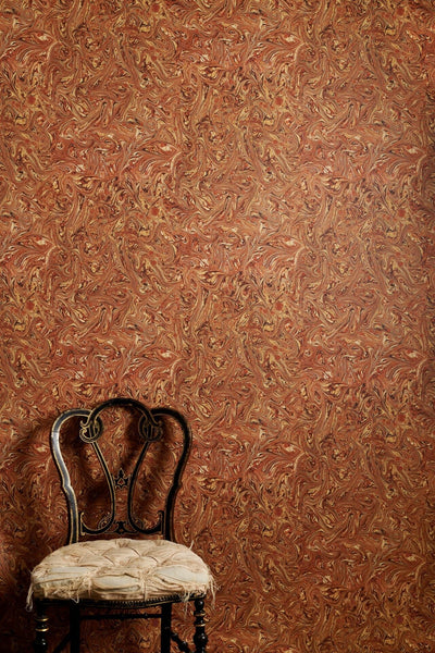 Meredith Rouge marbled wallpaper with dense swirling pattern in rich warm tones printed on wide 70cm roll
