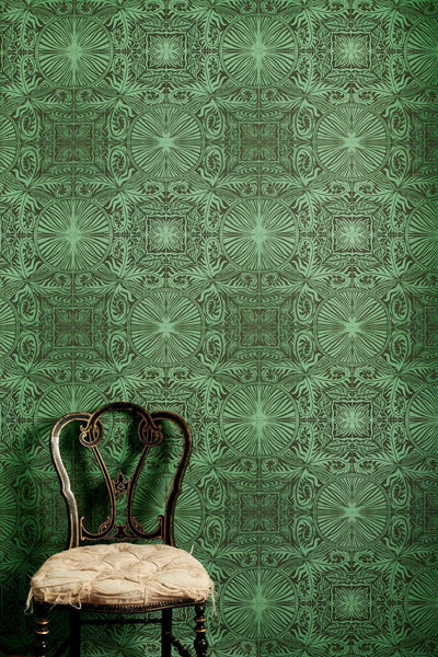 Party Room green geometric wallpaper with squares and circular motifs, lino print design in warm green and soft black on non-woven paste-the-wall paper