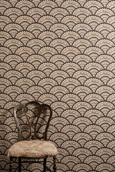 Clarice Noire wallpaper with scalloped geometric pattern in soft black, muted orange and sand tones inspired by 1930s design