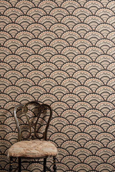 Clarice Noire wallpaper with scalloped geometric pattern in soft black, muted orange and sand tones inspired by 1930s design