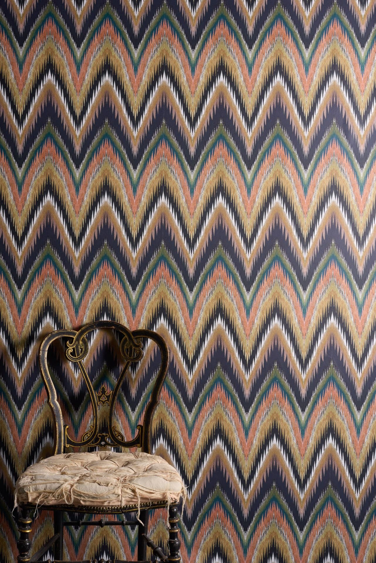 Ziggy wallpaper with energetic zigzag flamestitch pattern created in coloured pencil and metallic tones with a modern distressed finish