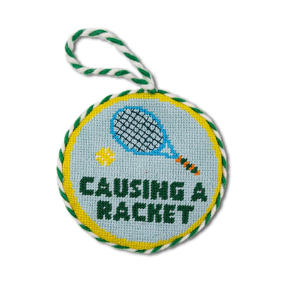Round dog toy with tennis racket design and text 'Causing a Racket' on a white background
