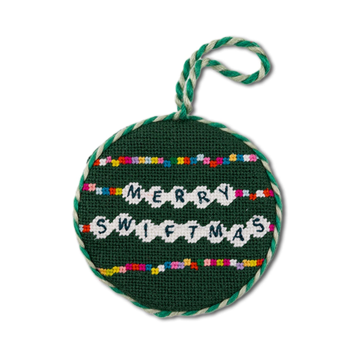Round green needlepoint ornament with 'Merry Swiftmas' text and colorful accents on a white background