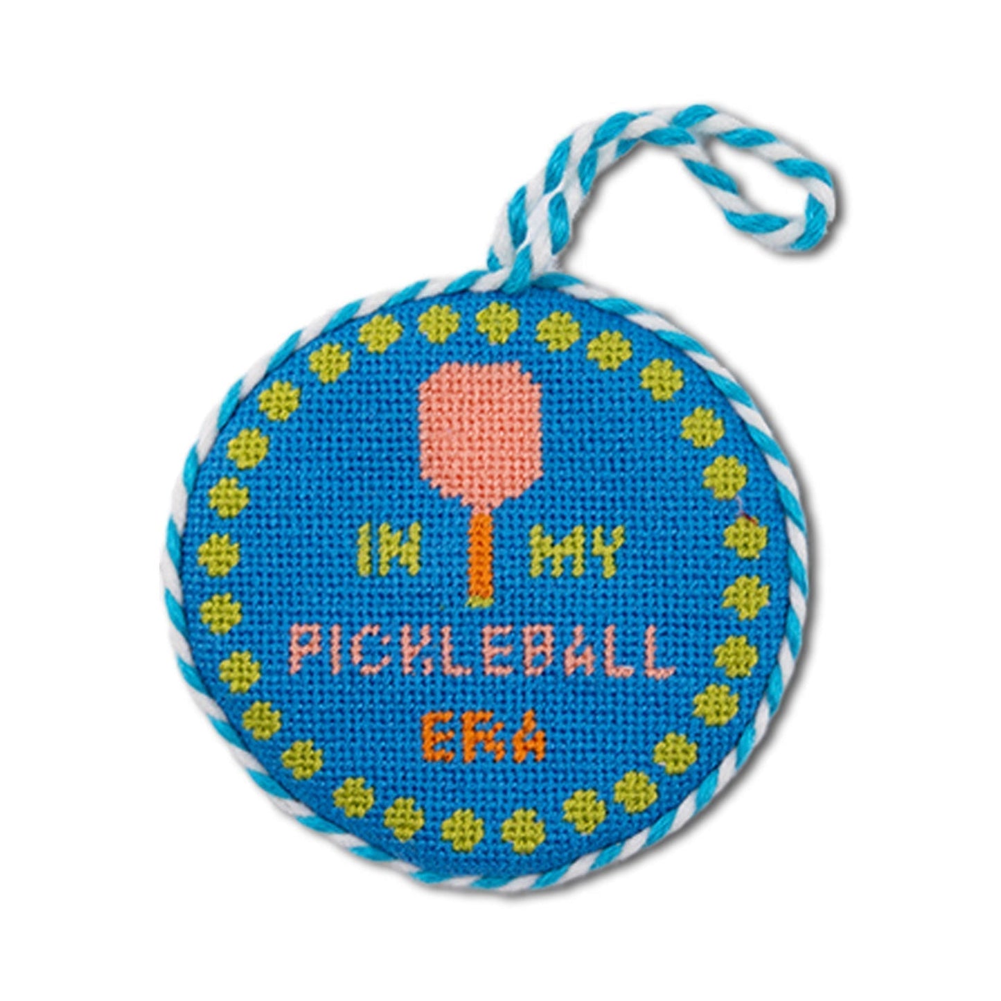Cross-stitched pickleball-themed ornament with text and paddle design on a blue background.
