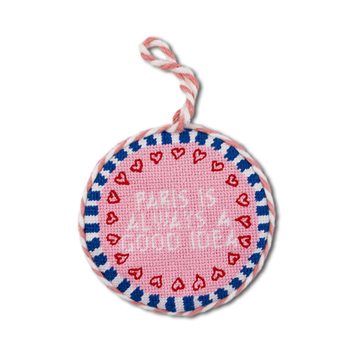 Round pink fabric tag with red hearts and text, attached to a string on a white background