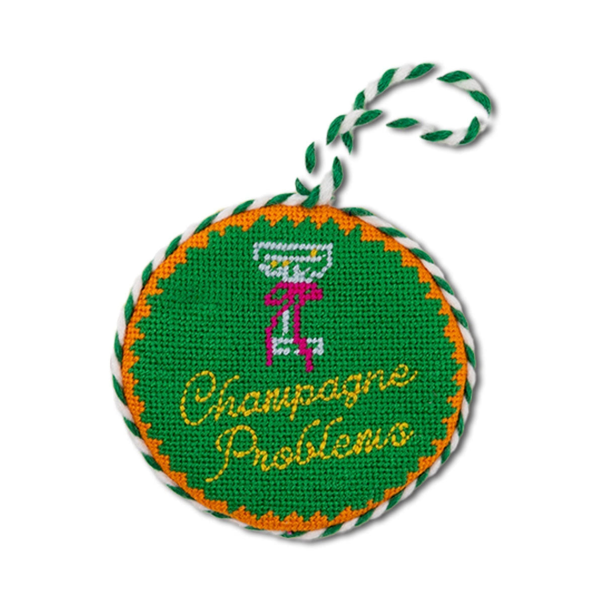 Round needlepoint ornament with 'Champagne Problems' text and martini glass design on green background.