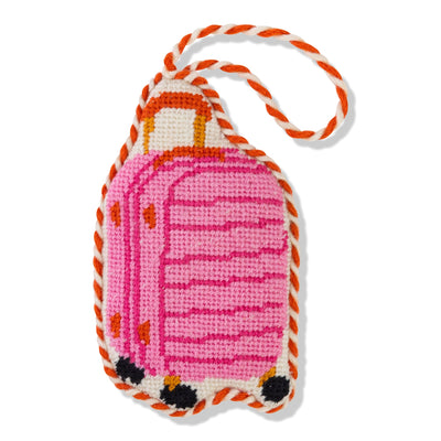 Pink suitcase-shaped keychain with orange accents on a white background