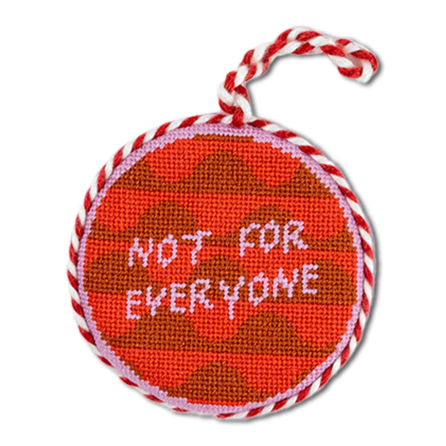 Round red object with brown pattern and 'Not for Everyone' text, tied with red and white string on a white background.