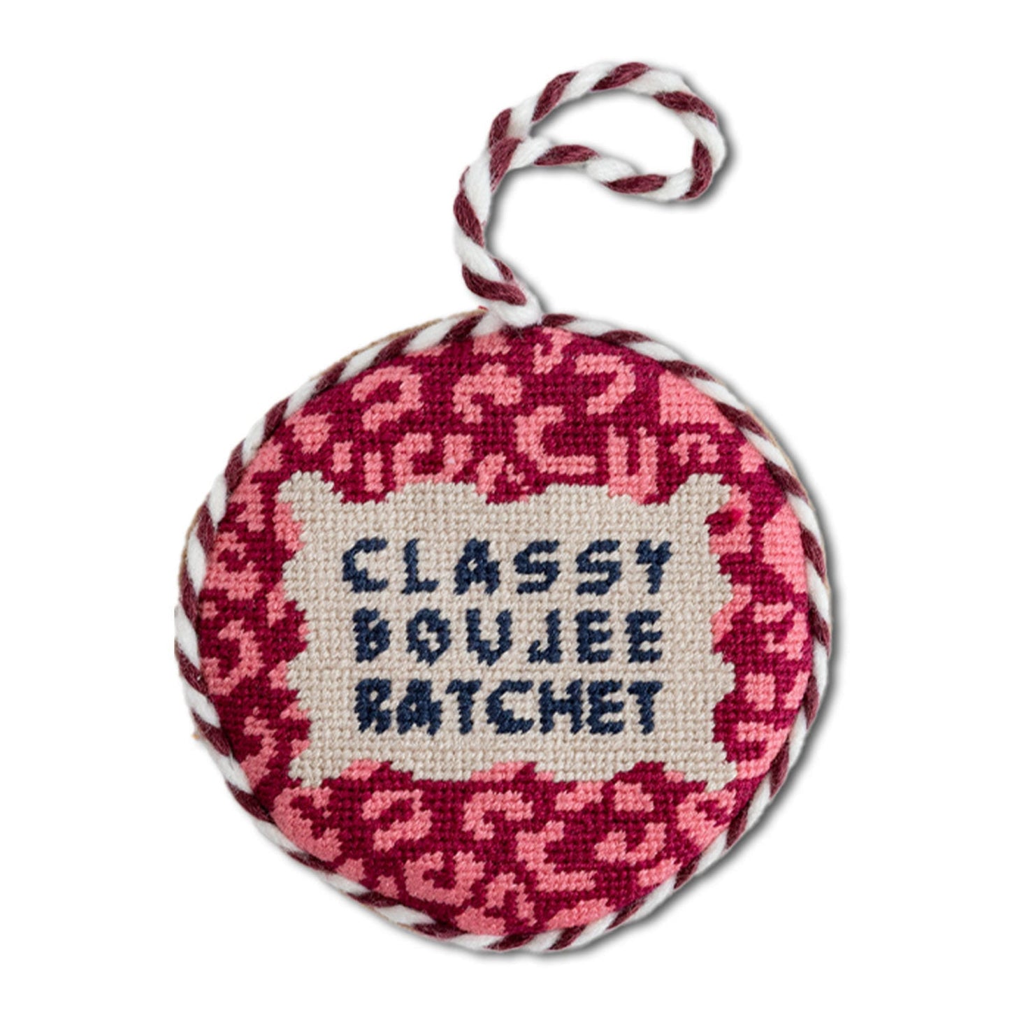 Round needlepoint ornament with pink cheetah pattern and 'Classy Boujee Ratchet' text on a white background