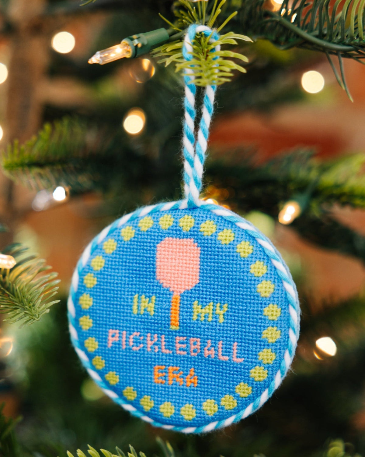 Decorative ornament with pickleball design on a Christmas tree