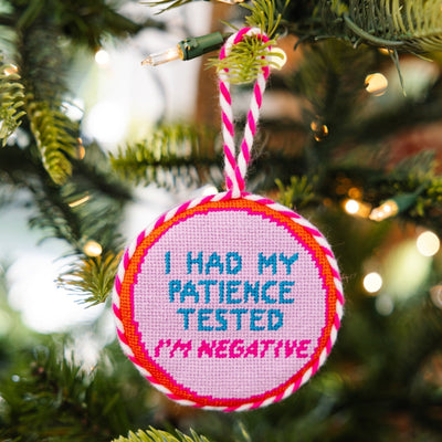 Decorative ornament with 'I had my patience tested. I'm negative.' text on a Christmas tree.