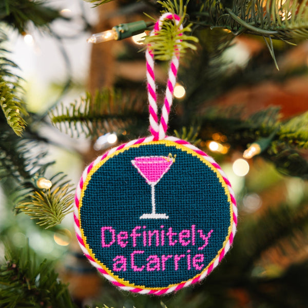 Decorative ornament with 'Definitely a Carrie' text on a Christmas tree.