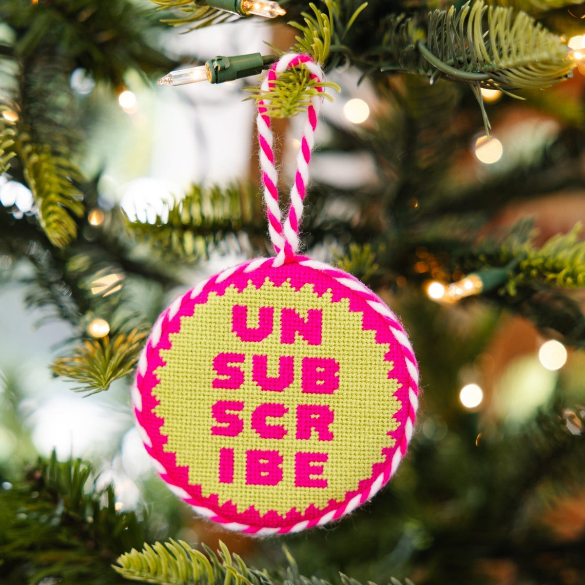 Decorative ornament with 'UN SUBSCRIBE' text on a Christmas tree.