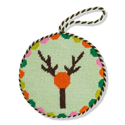 Round needlepoint ornament with deer design on a light green background