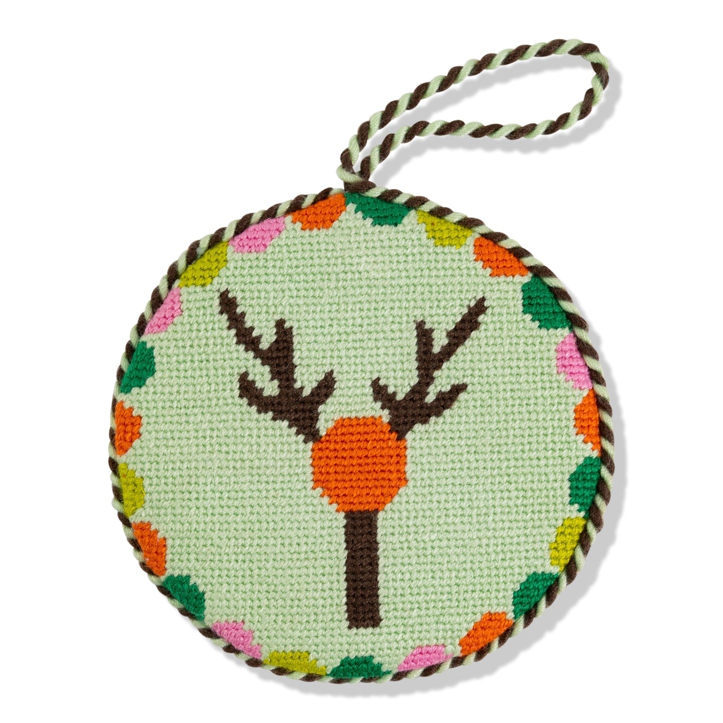 Round needlepoint ornament with deer design on a light green background