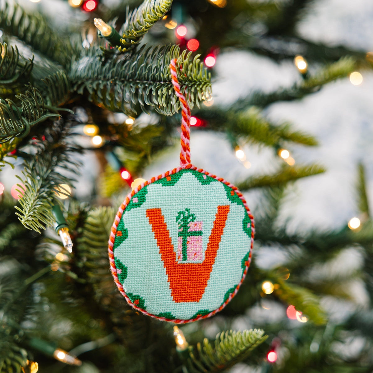 Decorative Christmas ornament with a letter 'V' on a Christmas tree.