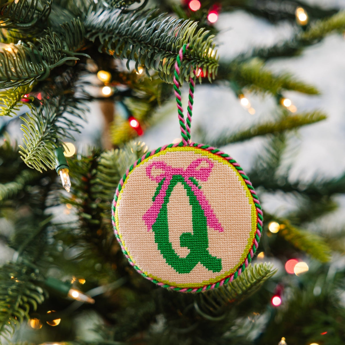 Decorative Christmas ornament with letter 'Q' on a tree