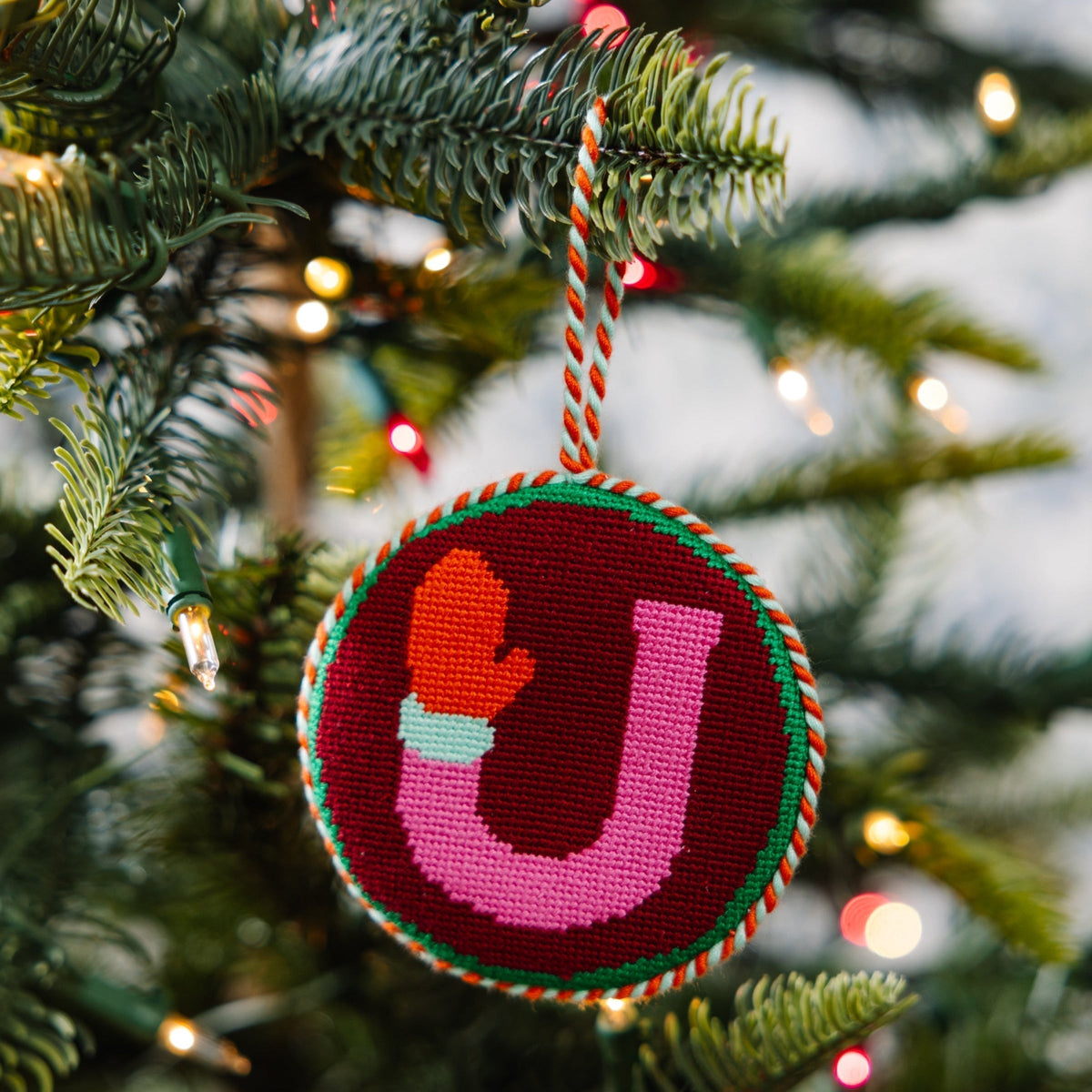 Decorative Christmas ornament with letter 'U' on a tree