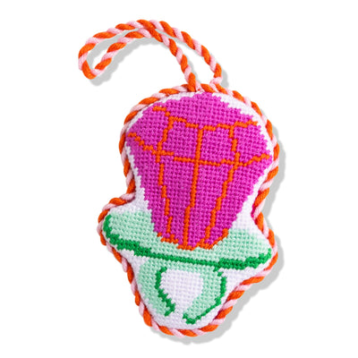 Colorful dog toy with pink center, green base, and orange rope on a white background