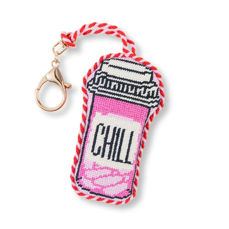 Keychain with a pink and white design and 'CHILL' text on a white background