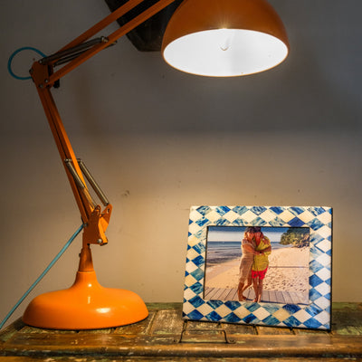 Orange lamp with a photo frame on a wooden surface