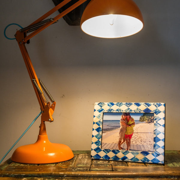 Orange lamp with a photo frame on a wooden surface
