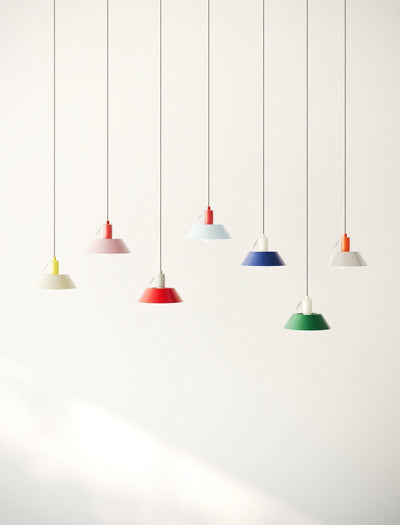 FIFTY FIFTY Lamp group of seven colorful pendant lamps with metal shades hanging against a white wall.