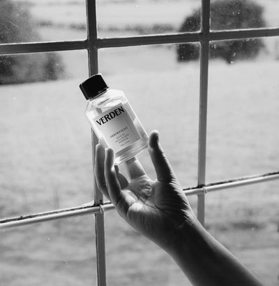 Arborealist Bath Oil held in front of window
