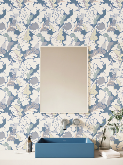 Bathroom with floral wallpaper by Lizzet Frausto, blue sink, and decorative elements.