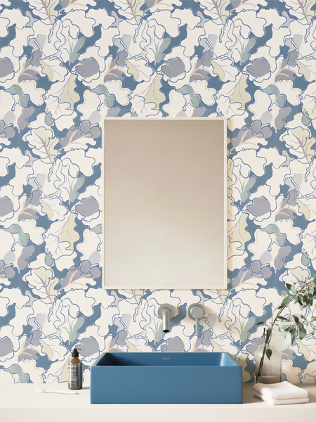 Bathroom with floral wallpaper by Lizzet Frausto, blue sink, and decorative elements.