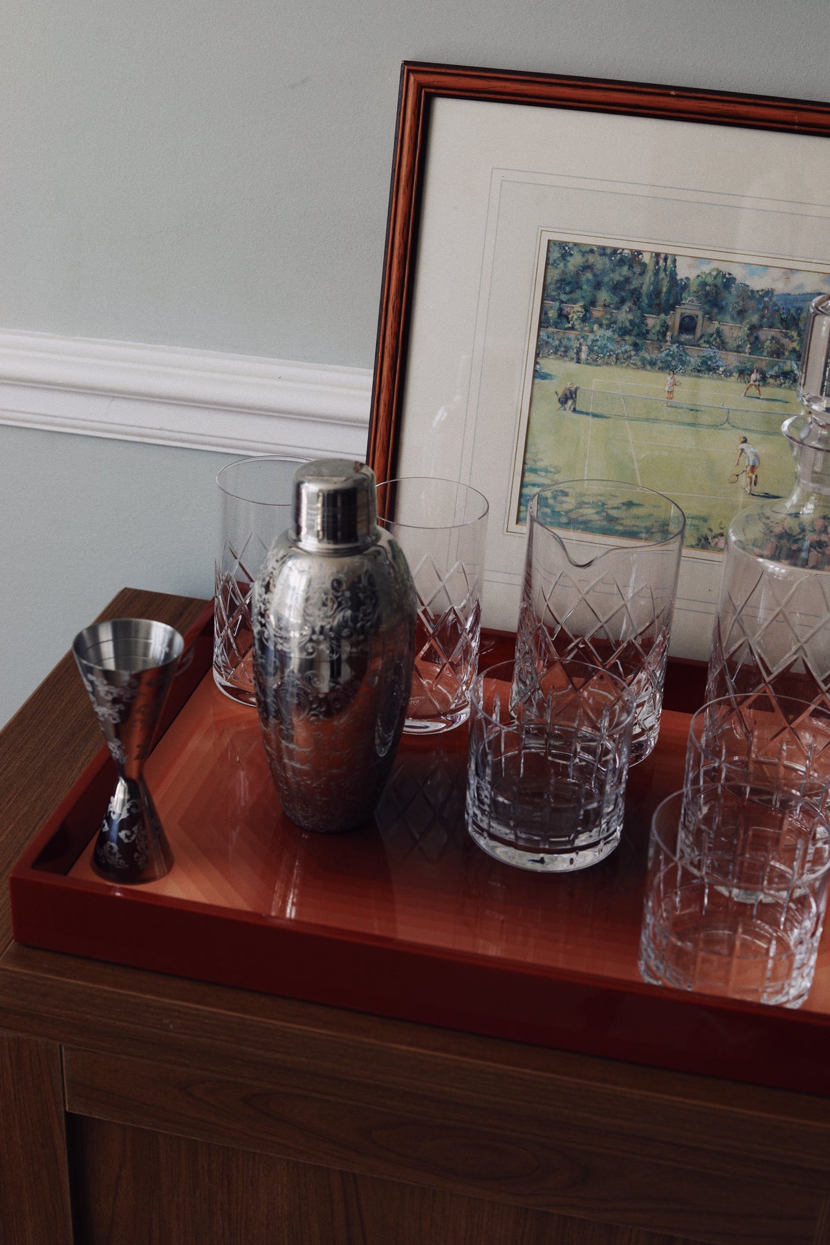 High gloss lacquer tray protecting wooden sideboard from crystal glass scratches and cocktail shaker spills