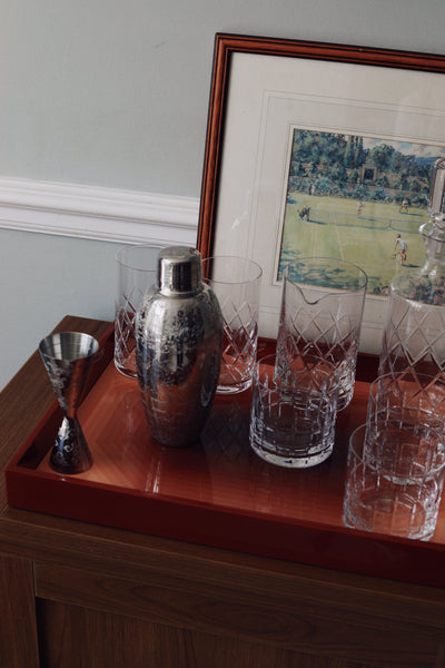 High gloss lacquer tray protecting wooden sideboard from crystal glass scratches and cocktail shaker spills