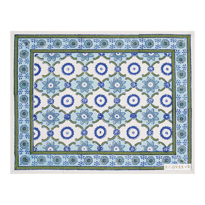 A rectangular cotton table mat with a hand-block printed geometric pattern in blue and green hues.