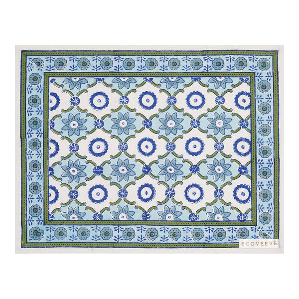A rectangular cotton table mat with a hand-block printed geometric pattern in blue and green hues.