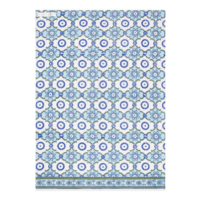 A folded handcrafted cotton tea towel with a geometric pattern in blue and white.