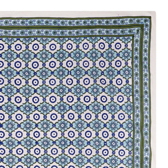 A rectangular tablecloth with a floral pattern in shades of blue and green, displayed on a white background.