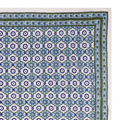 A rectangular tablecloth with a floral pattern in shades of blue and green, displayed on a white background.