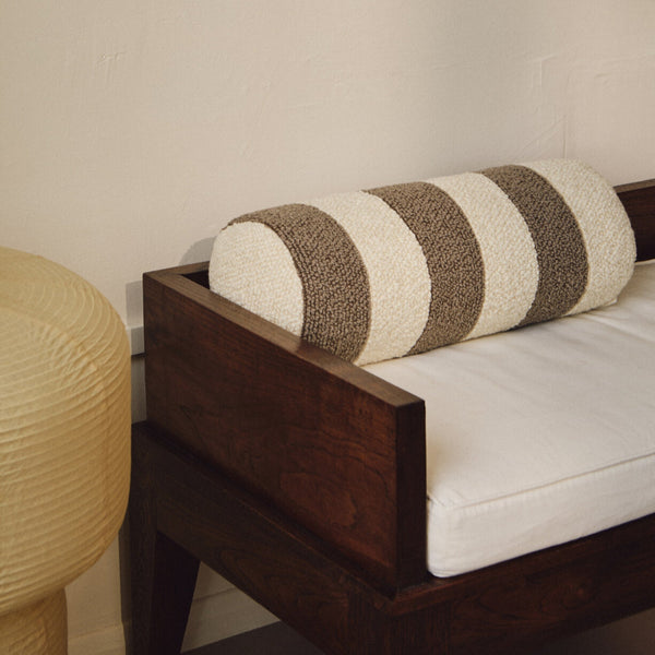 Lifestyle closeup of cream and beige wool bouclé striped bolster cushion