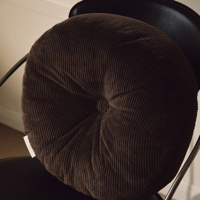 Close up shot of brown cotton corduroy round cushion on chair
