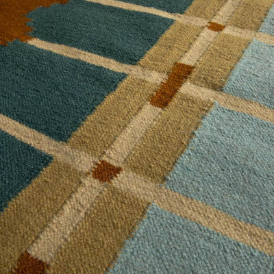 Close-up detail of Corbie handwoven flatweave wool rug showing geometric design in teal blue, light blue, ochre yellow and caramel brown tones.