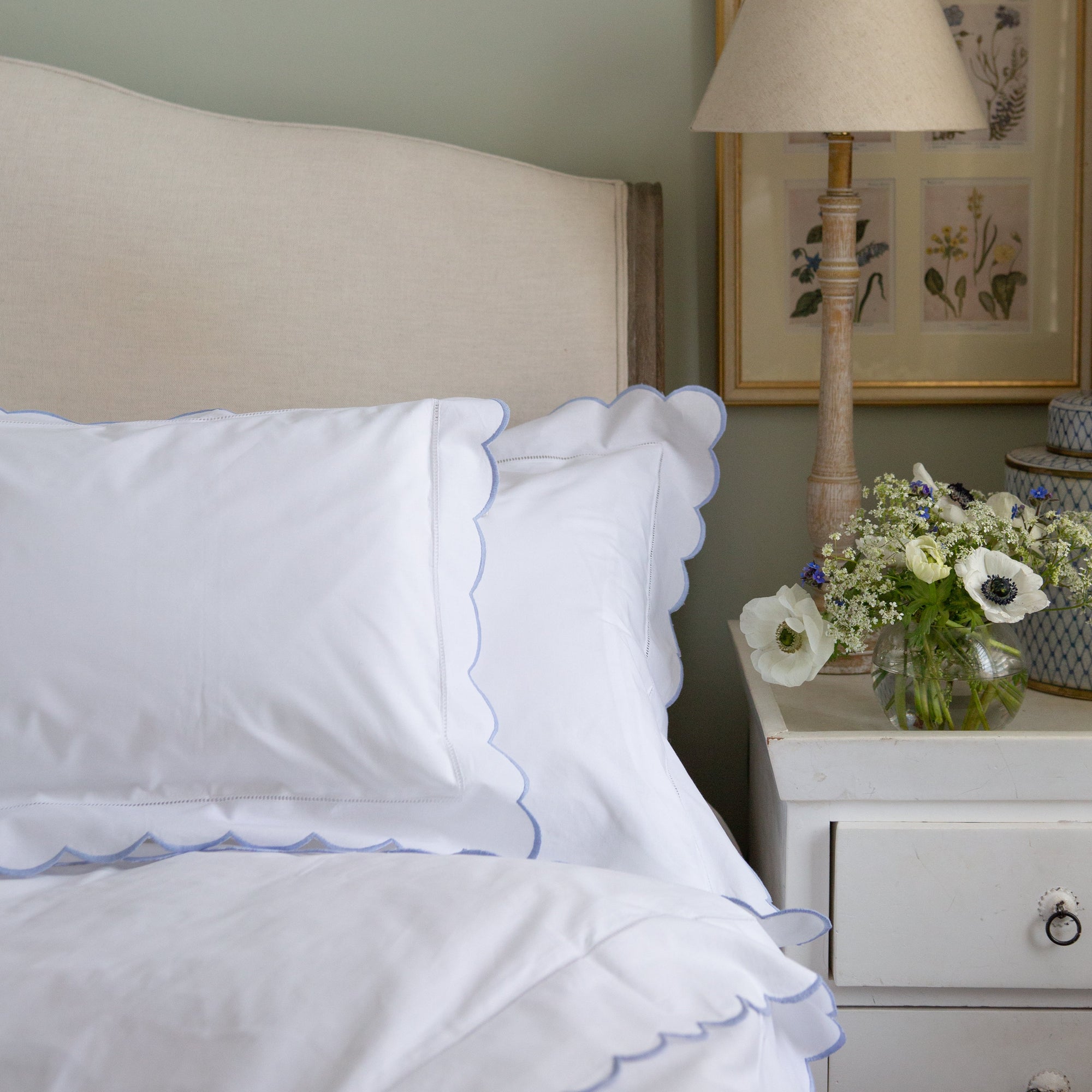 Beautiful white cotton duvet cover featuring a stunning blue scalloped edge border.